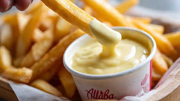Crispy fries dipped in garlic sauce at Albaik BBQ Baik.