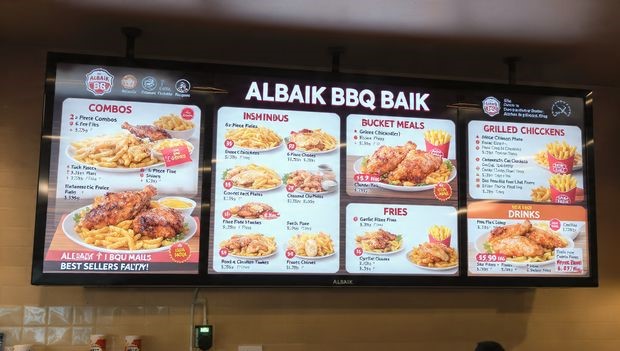 Albaik BBQ Baik menu board displaying combo meals, bucket options, and prices.