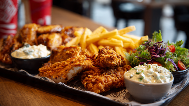 Albaik BBQ Baik signature grilled and fried chicken platter with fries and garlic sauce.