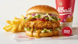 Albaik Big Baik Burger on wrapper with fries, drink, branded cup, show crunchy chicken fillet and signature sauce