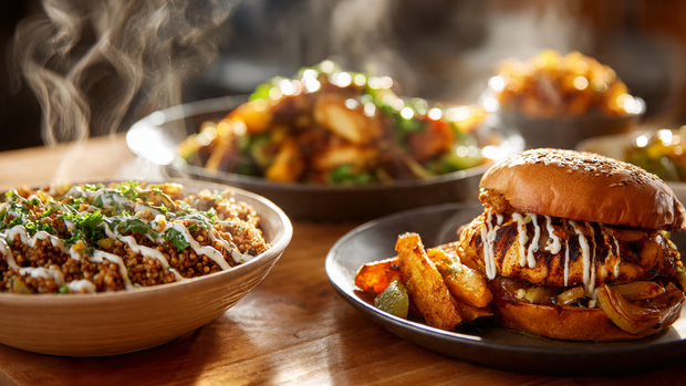 Garlic sauce drizzled on shawarma bowl, burger, and roasted vegetables.