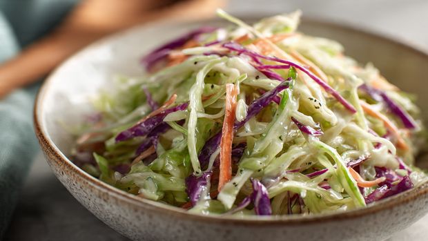 Close up of creamy Albaik style coleslaw showing shredded cabbage and dressing